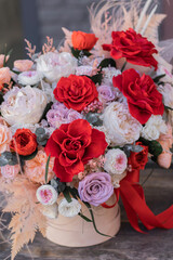 Red rose and peach peonies in a big round box for mother's day, valentine's day, Woman's day 8 march.