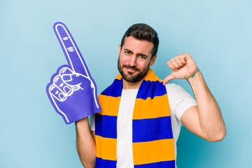 Young sports fan man isolated on blue background feels proud and self confident, example to follow.