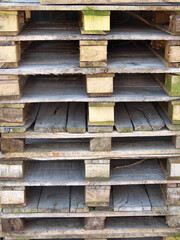 Old wooden pallets are stacked.