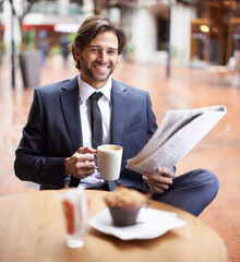 Some time to myself in the midst of a busy day. A businessman having a coffee break while reading the news.