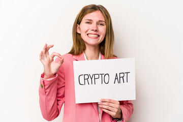Young English business woman holding a crypto money placard isolated on white background cheerful and confident showing ok gesture.