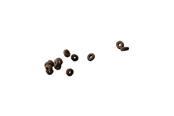 Chocolate rings cereal spill out into a bowl. Breakfast.