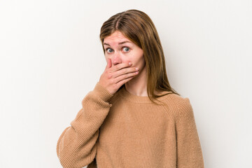 Young russian woman isolated on white background covering mouth with hands looking worried.