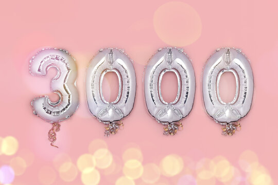 Balloon Bunting for celebration of 3000 made from Silver Number Balloons on pink background. Holiday Party Decoration or postcard concept with top view