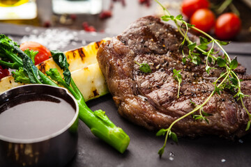 Black Angus New York steak. Marbled beef sirloin from Uruguay. Delicious healthy traditional food closeup served for lunch in modern gourmet cuisine restaurant