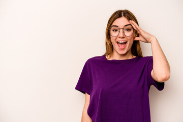 Fototapeta premium Young caucasian woman isolated on white background shouts loud, keeps eyes opened and hands tense.