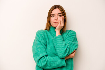 Young caucasian woman isolated on white background blows cheeks, has tired expression. Facial expression concept.