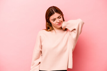 Young caucasian woman isolated on pink background having a neck pain due to stress, massaging and...