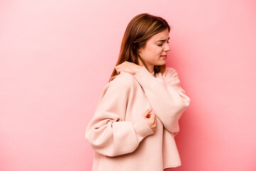 Young caucasian woman isolated on pink background having a shoulder pain.