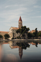 Vertical shot of St. Lawrence Cathedral with reflection in the water in daylight