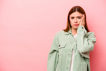 Young caucasian woman isolated on pink background who feels sad and pensive, looking at copy space.