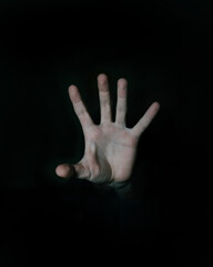 Selective of an open hand in the darkness