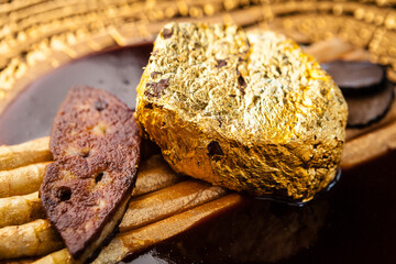 Black Angus 24 carat gold steak. Beef tenderloin, foie gras, fresh black truffle, white asparagus, port wine sauce. Delicious food closeup served for lunch in modern gourmet cuisine restaurant