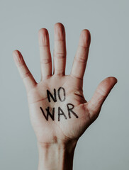 text no war written in the palm of a mans hand