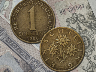 Closeup of an old Austrian coin (1 schilling) isolated on banknotes background