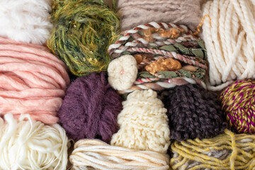 Fototapeta na wymiar balls and skeins of yarn and wool for knitting and weaving