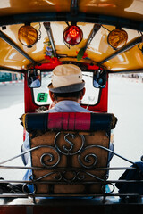 Vertical shot of a person driving a colorful taxi in Bangkok, Thailand