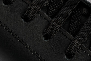 Close-up shot of a detail of black laces of sneakers
