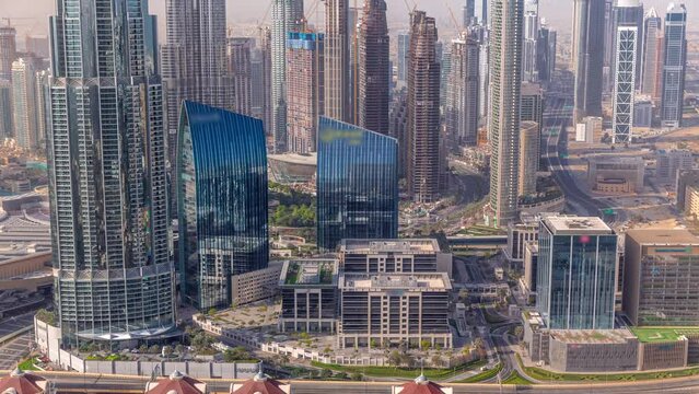 Aerial view of tallest towers in Dubai Downtown skyline and highway timelapse.