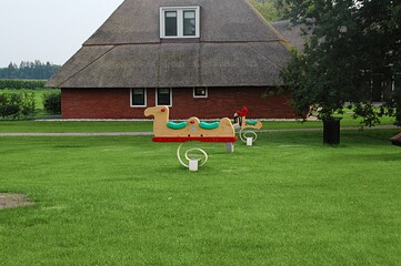 Obraz na płótnie Canvas Farmhouse and childrens playground