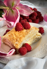 puff pastry with raspberry on plate. Tasty slice of homemade layered traditional cake napoleon
