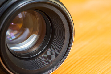 Manual photo lens on a blurred background. Photography equipment. Specially defocused photo.