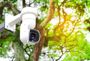 Modern public CCTV camera on a electric pole with blurred natural background. Intelligent recording cameras for monitoring all day and night. Concept of surveillance and monitoring with copy space.