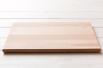 Perspective view of wooden cutting board on wooden background. Empty space for your design