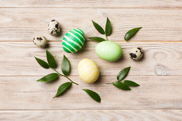 Colorful Easter eggs with spring flower leaf isolated over white background. Colored Egg Holiday border