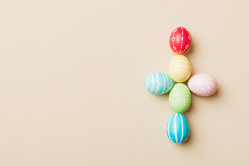 holiday preparation Multi colors Easter eggs on colored background, cross show the religious and secular side of Easter. Pastel color Easter eggs. holiday concept with copy space