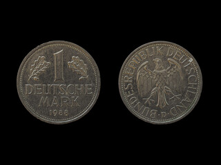 Top view of the front and back of a historic West Germany deutsche mark coin on a black background