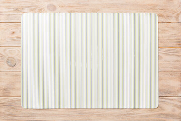 Top view of light tablecloth for food on wooden background. Empty space for your design