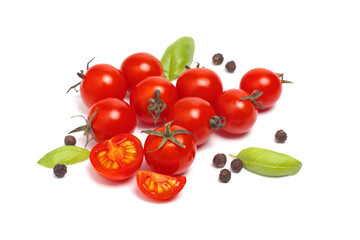Cherry tomatoes with spices isolated on white background, selective focus in the foreground.