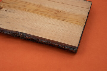 Piece of wooden log on orange leather background. The unique minimal scene idea.