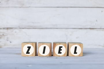 ziel concept written on wooden cubes or blocks, on white wooden background.