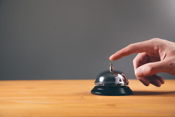 finger on the call button on table