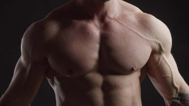 Athletic man tensing his pectoral muscles