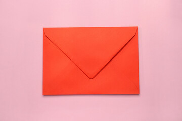 Red envelope on pink background, top view