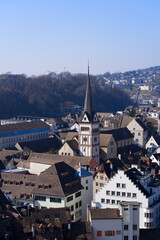Fototapeta na wymiar Aerial view over City of Schaffhausen with Minster Church seen from historic fortification named Munot on a sunny spring day. Photo taken March 5th, 2022, Schaffhausen, Switzerland.
