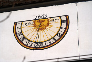 Sundial at facade of medieval protestant church St. Johann at the old town of Schaffhausen on a sunny spring day. Photo taken March 5th, 2022, Schaffhausen, Switzerland.