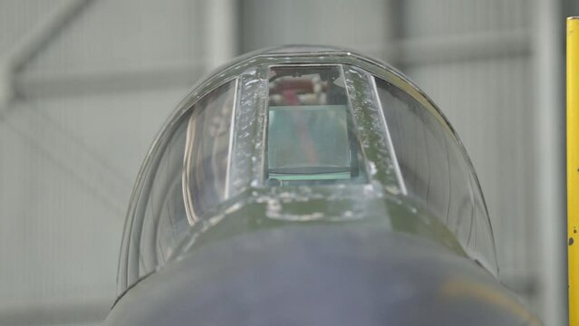 Air Force Jet Fighter in Hangar, Red Ribbon on Jet Fighter Pitot Tube Cover. Close Up.