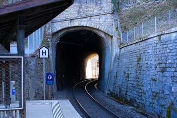Empty platform with tunnel portal at train station Laufen Castle at Rhine Falls on a sunny spring day. Photo taken March 5th, 2022, Zurich, Switzerland.