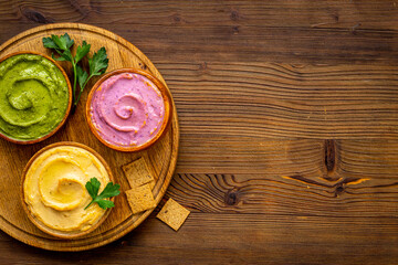 Various types of hummus with chickpeas spinach and beets. Flatlay top view