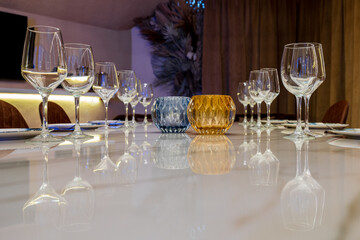 Wineglasses and plates on marble dining table