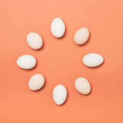 easter concept made with eggs in circle on brown orange background . Minimal food concept.