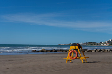 Ring-shaped lifebuoy with lifeline. beach background.