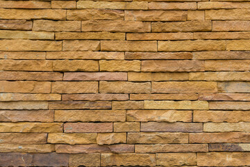 Brick wall background is a wall made of clay bricks, giving the structure strength and cement line between bricks that looks beautiful. It is popular to build a wall of ancient monuments.copy space,