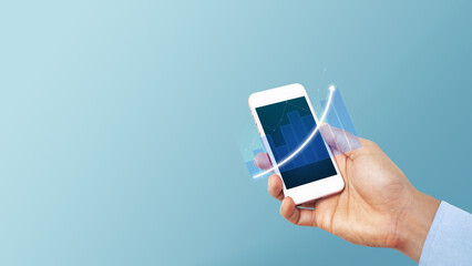 Businessman holding smartphone or mobile phone with growth business graph. Business economic technology concept