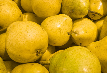 Food background yellow fresh ripe pears, close-up view from above, organic fruit concept