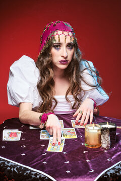 Female fortune teller pointing to tarot cards